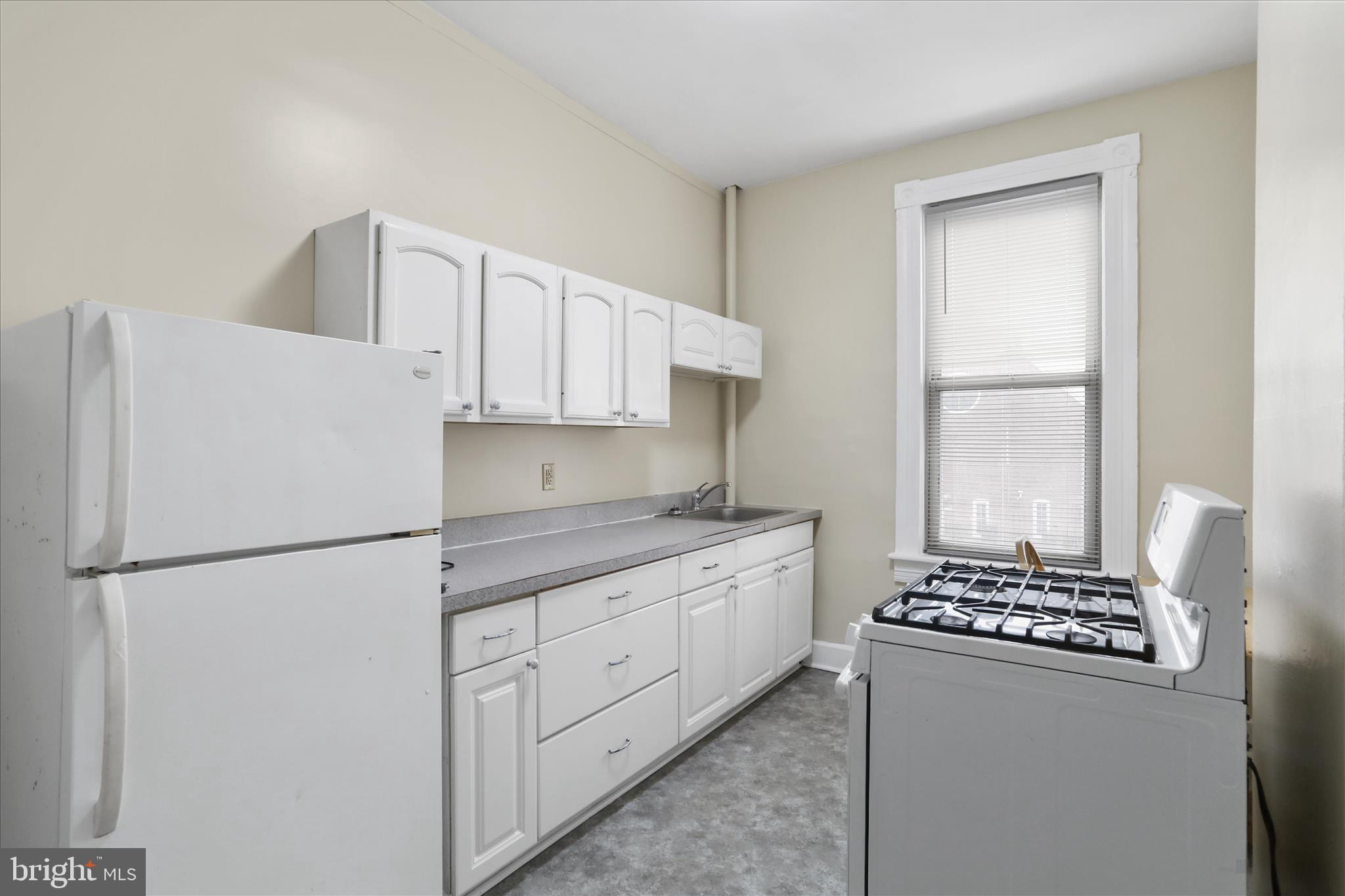 315 Frederick Street Cumberland, MD 21502 - Photo 10 of 46 a kitchen with appliances a refrigerator and a stove top oven