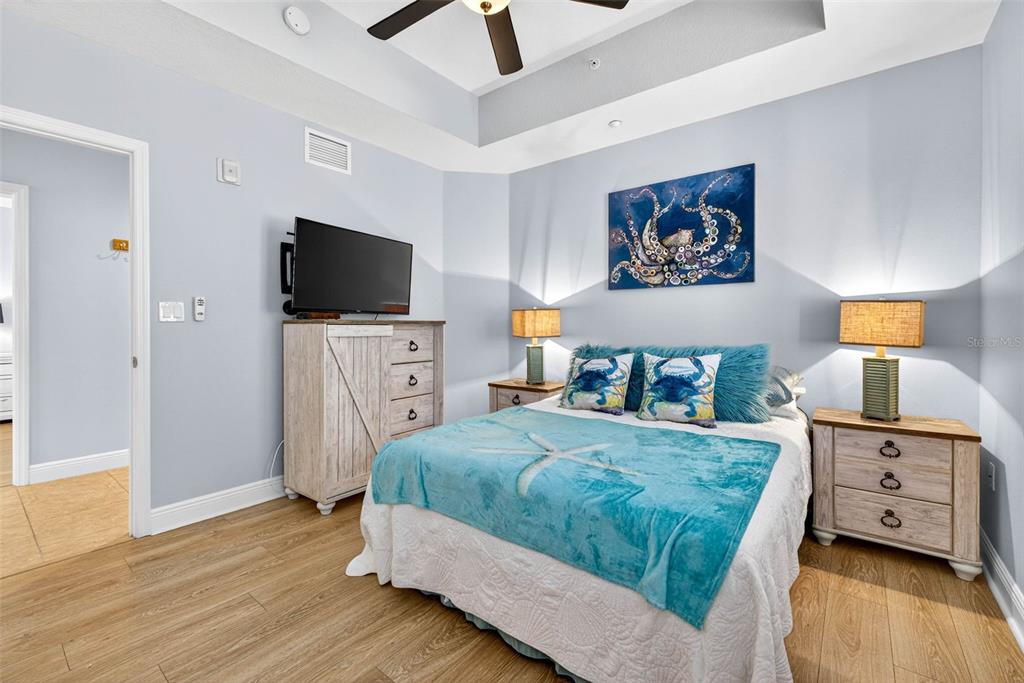 17717 Gulf Boulevard, Unit 401 Redington Shores, FL 33708 - Photo 18 of 66 a bedroom with a bed and a flat screen tv