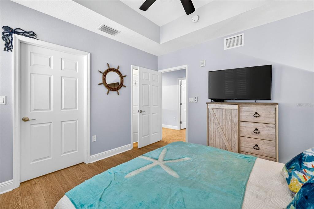 17717 Gulf Boulevard, Unit 401 Redington Shores, FL 33708 - Photo 19 of 66 a living room with flat screen tv and a dresser