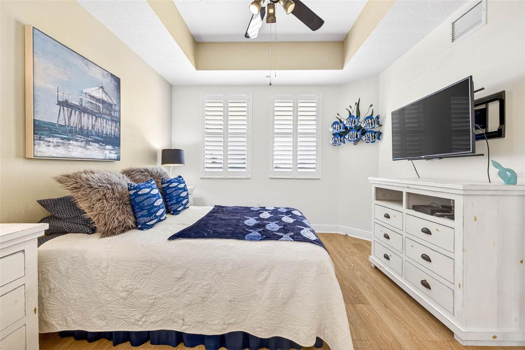 17717 Gulf Boulevard, Unit 401 Redington Shores, FL 33708 - Photo 22 of 66 a bedroom with a bed a flat screen tv and a window