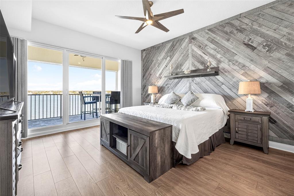 17717 Gulf Boulevard, Unit 401 Redington Shores, FL 33708 - Photo 26 of 66 a spacious bedroom with a bed and wooden floor