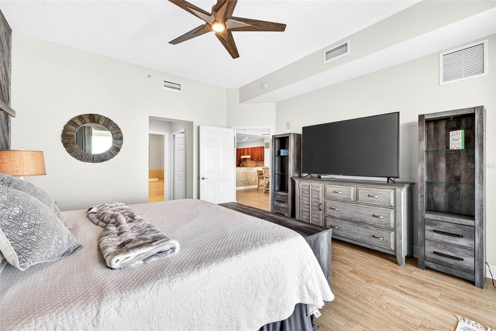 17717 Gulf Boulevard, Unit 401 Redington Shores, FL 33708 - Photo 28 of 66 a bedroom with a bed and a flat screen tv
