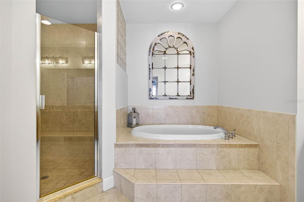17717 Gulf Boulevard, Unit 401 Redington Shores, FL 33708 - Photo 32 of 66 a bathroom with a bathtub and a shower