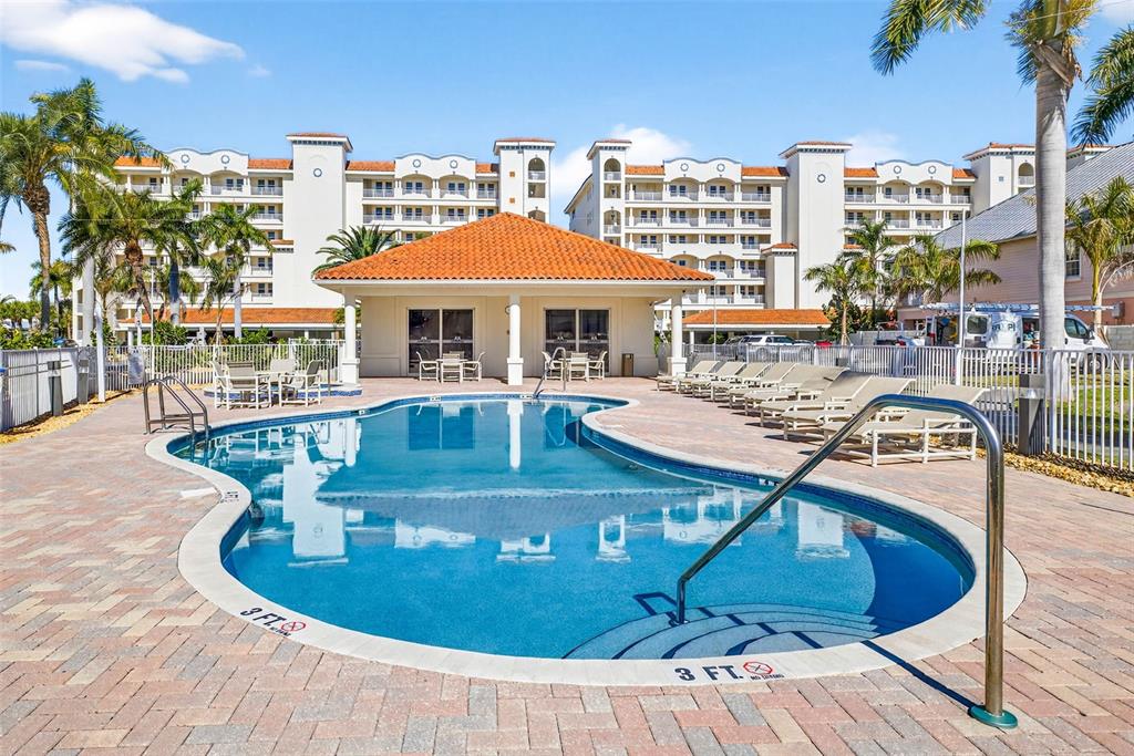 17717 Gulf Boulevard, Unit 401 Redington Shores, FL 33708 - Photo 56 of 66 a view of a swimming pool with outdoor seating