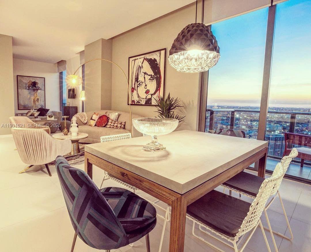 501 Northeast 31st Street, Unit PH4405 Miami, FL 33137 - Photo 4 of 18 a dining room with furniture and a chandelier