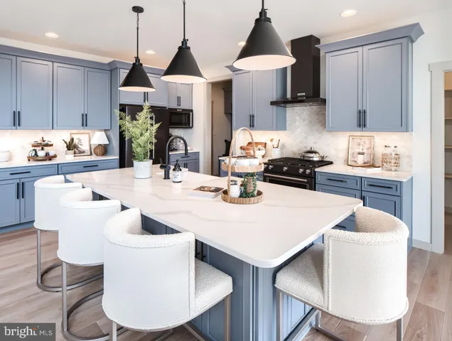 a kitchen with a dining table chairs and white appliances
