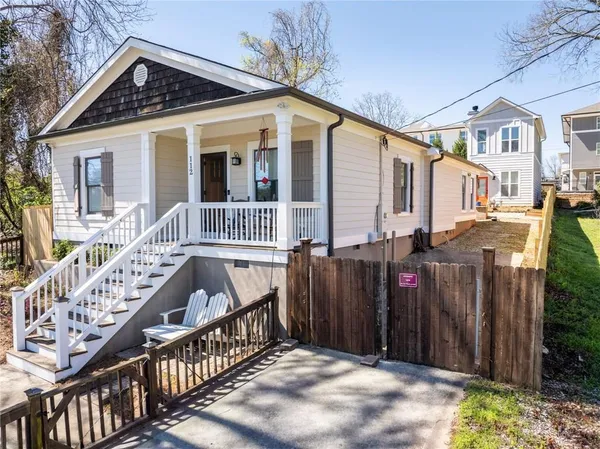 a view of a house with wooden fence