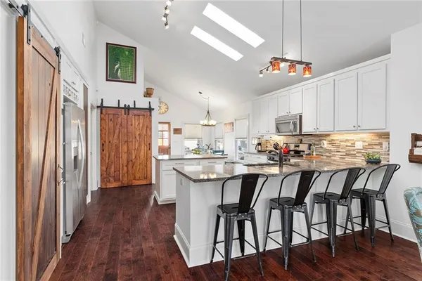 a kitchen with granite countertop stainless steel appliances and wooden cabinets