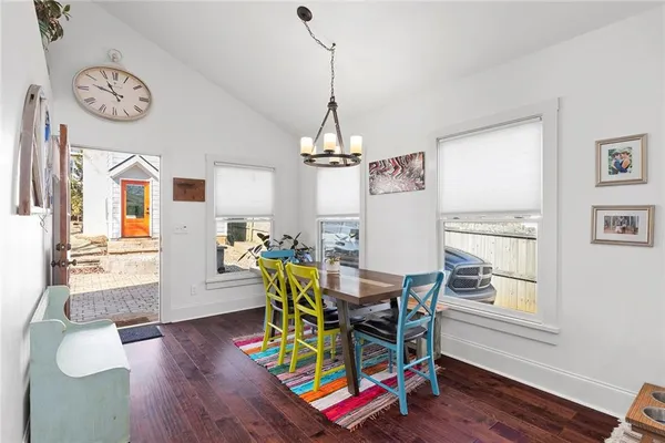a living room with stainless steel appliances kitchen island granite countertop furniture and a dining table