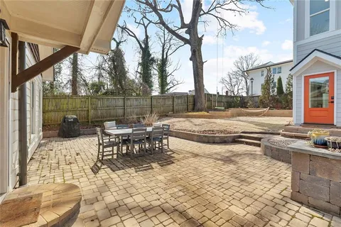 a view of a patio with couches and table and chairs with wooden floor