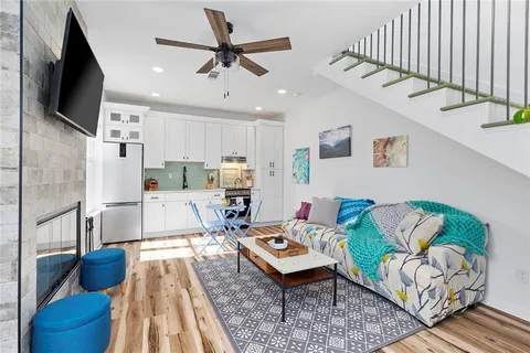 a view of kitchen with stainless steel appliances granite countertop a refrigerator and microwave