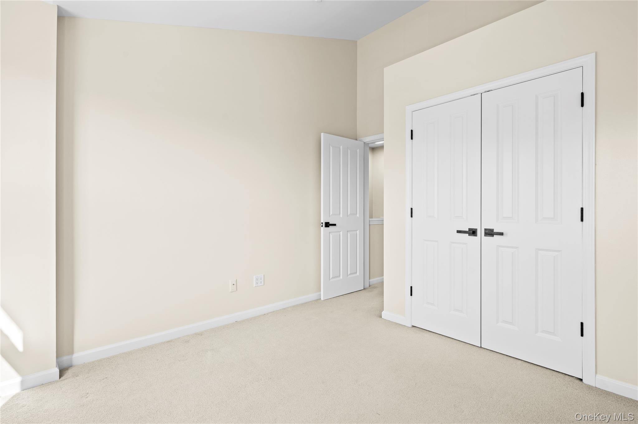 19 Putters Way, Unit 9 Middletown, NY 10940 - Photo 13 of 22 second bedroom with light carpet and a closet