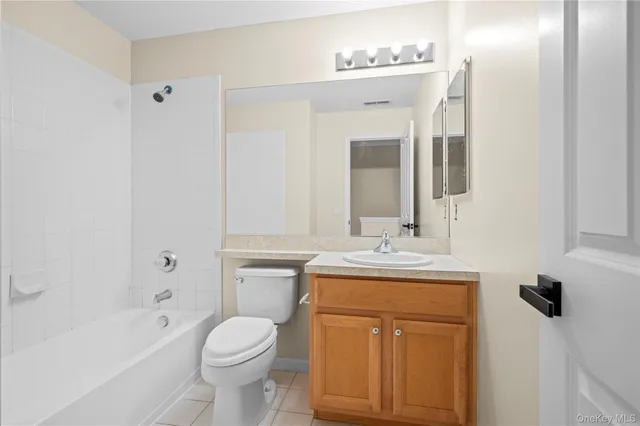 a bathroom with a toilet a sink a tub and mirror