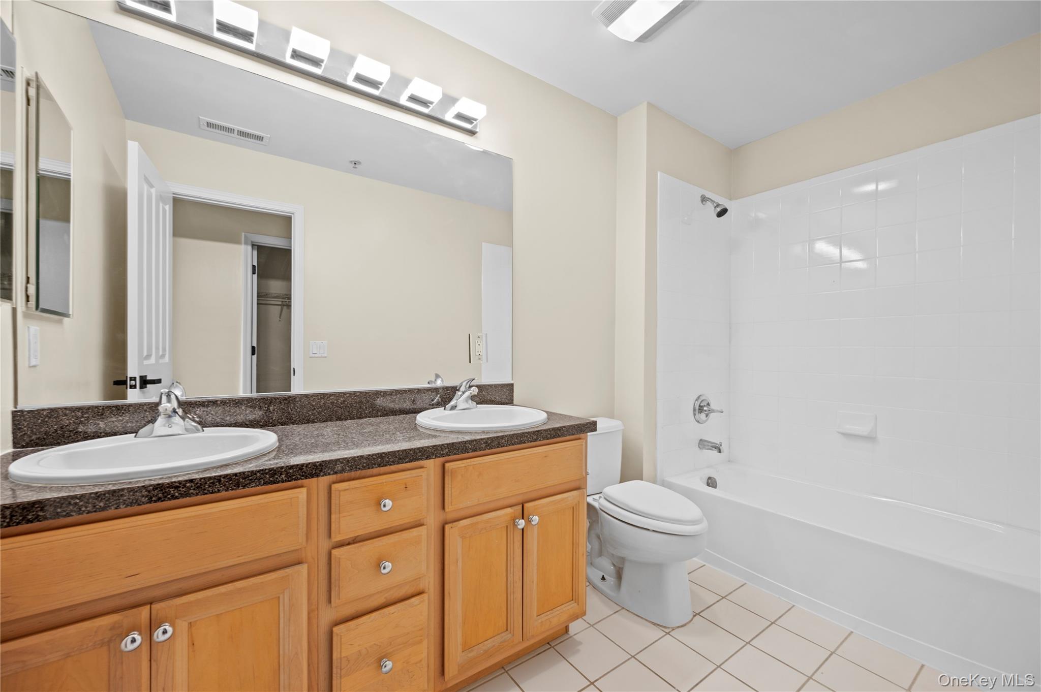 19 Putters Way, Unit 9 Middletown, NY 10940 - Photo 15 of 22 Full bathroom featuring light tile patterned floors, bathtub / shower combination, and double vanity