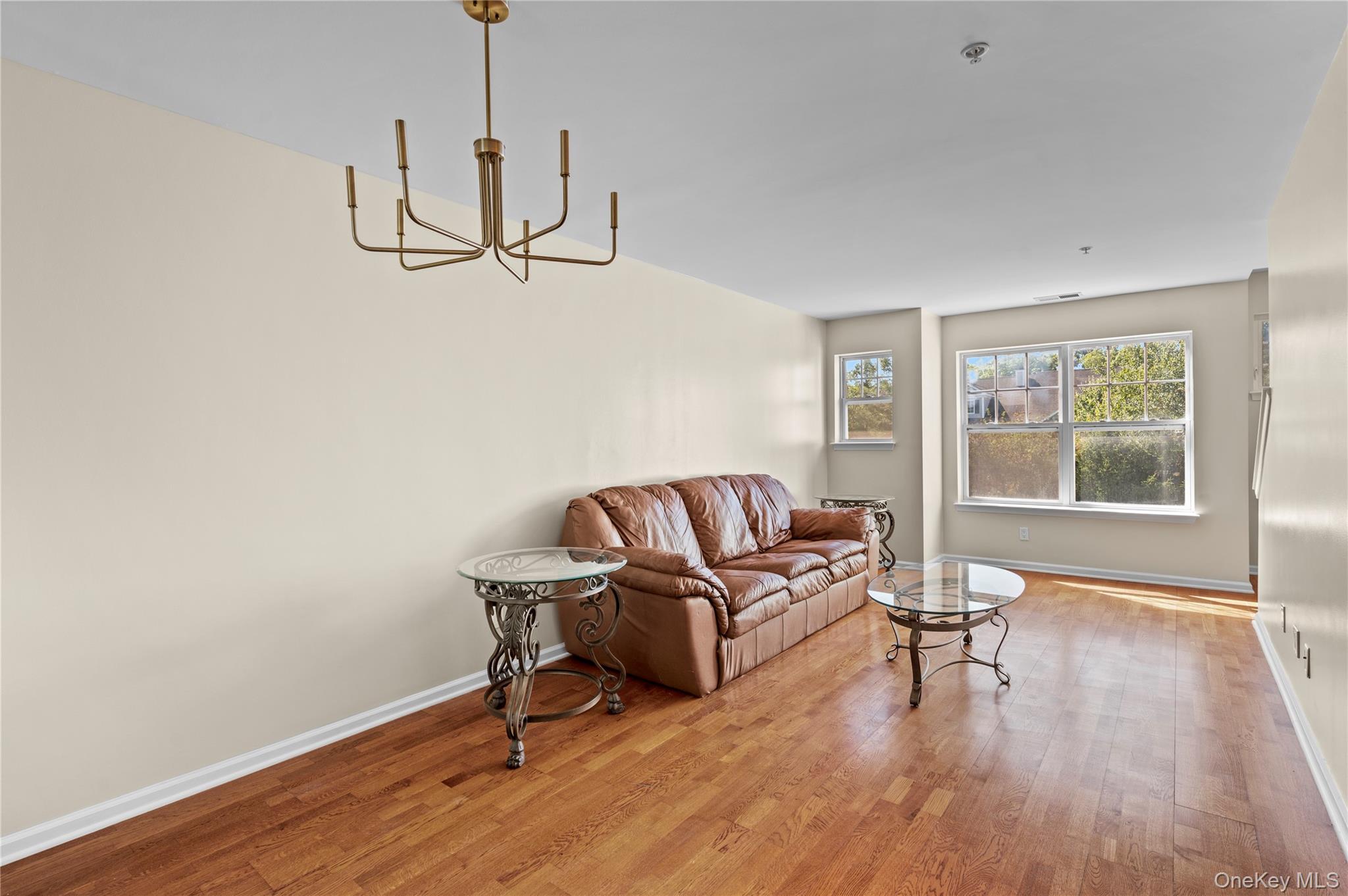 19 Putters Way, Unit 9 Middletown, NY 10940 - Photo 3 of 22 Living area with light wood finished floors and a chandelier