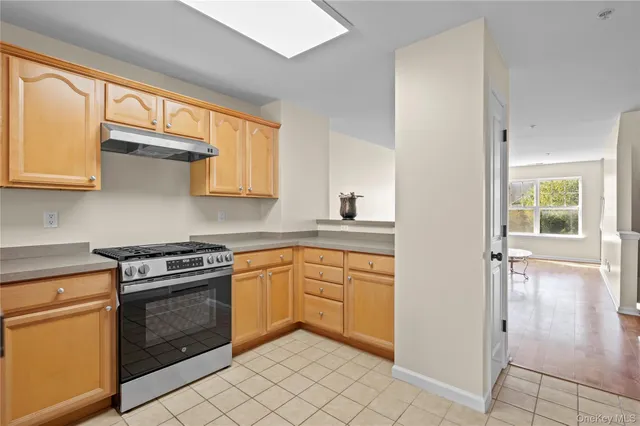 a kitchen with white cabinets and appliances
