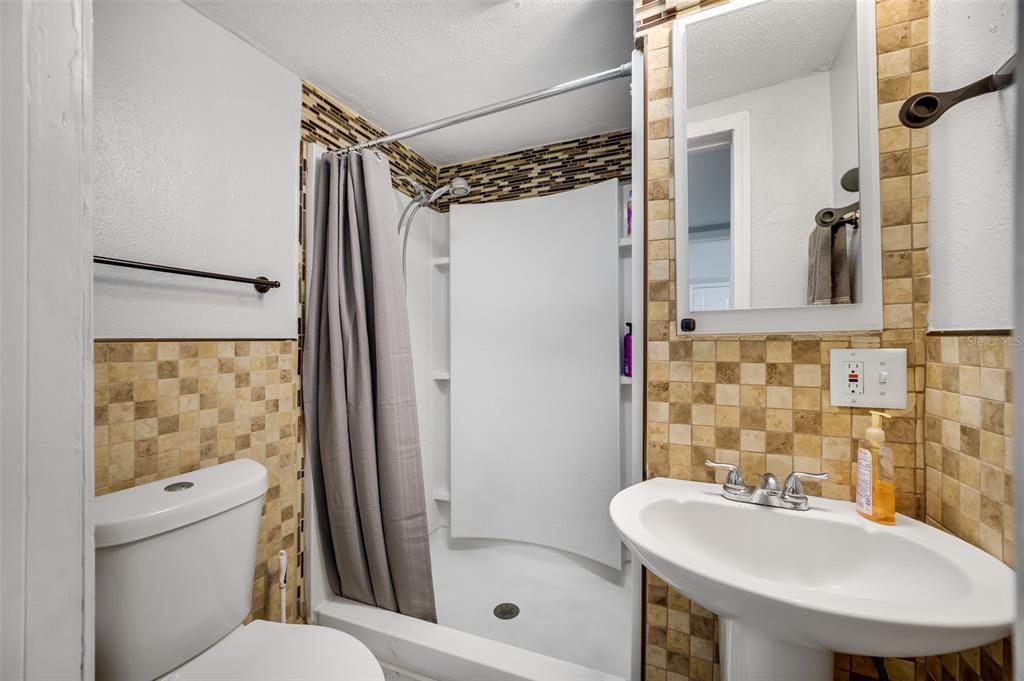 1601 Palm Way Largo, FL 33771 - Photo 15 of 25 a bathroom with a sink mirror toilet and shower