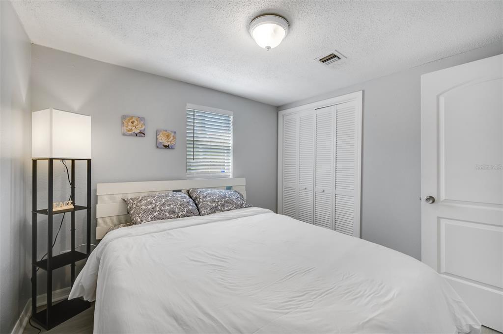 1601 Palm Way Largo, FL 33771 - Photo 17 of 25 a bedroom with a bed and wooden floor