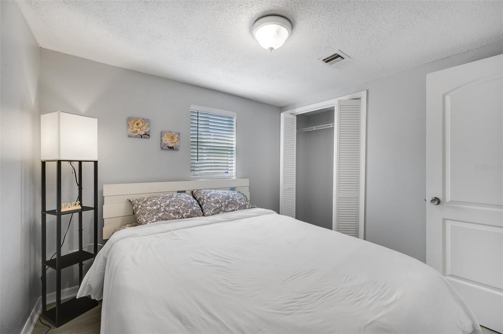 1601 Palm Way Largo, FL 33771 - Photo 19 of 25 a bedroom with a bed and wooden floor