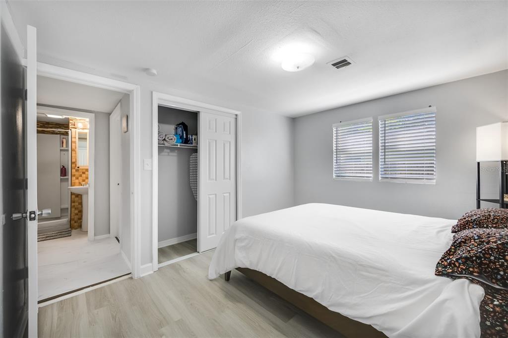 1601 Palm Way Largo, FL 33771 - Photo 21 of 25 a bedroom with a bed and a large mirror
