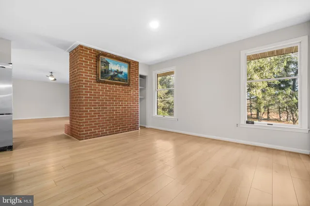 a kitchen with white cabinets and sink