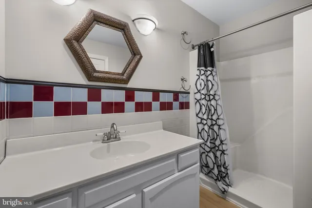 a bathroom with a sink a vanity and a mirror
