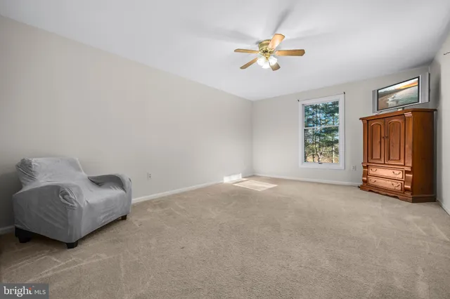 an empty room with closet and fan
