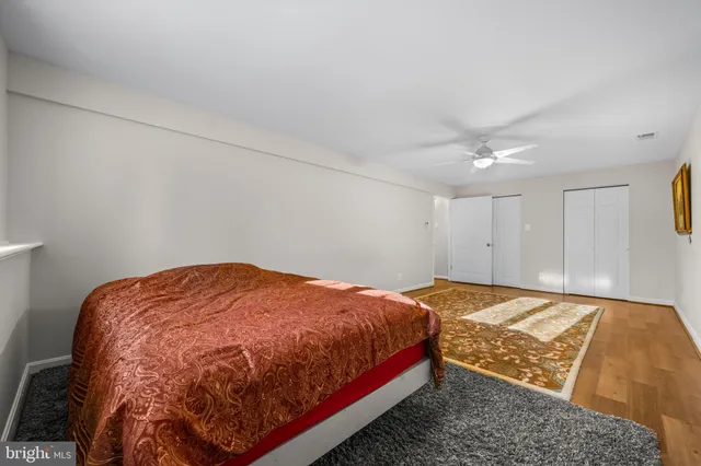 a view of a house with a large window and wooden fence