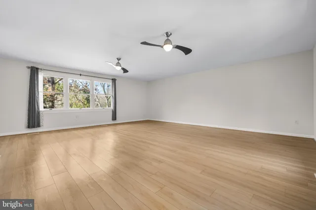 a view of a kitchen with wooden floor and a sink