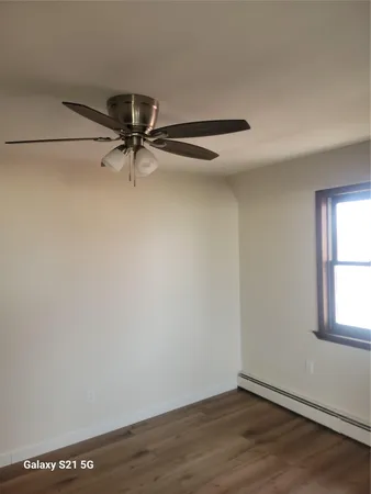 a bathroom with a granite countertop bathtub shower sink vanity and toilet