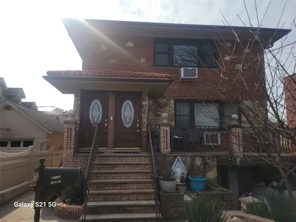 a front view of a house with stairs