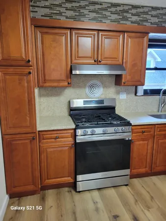 a stove top oven sitting inside of a kitchen