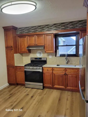a kitchen with stainless steel appliances granite countertop a stove a sink and a microwave