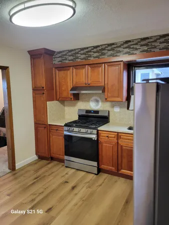 a kitchen with stainless steel appliances granite countertop a refrigerator stove and sink