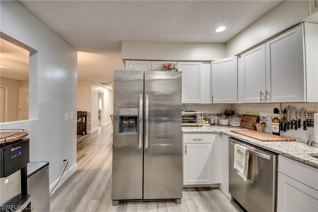 26508 Eager Road Punta Gorda, FL 33955 - Photo 21 of 41 a kitchen with stainless steel appliances a refrigerator sink and cabinets