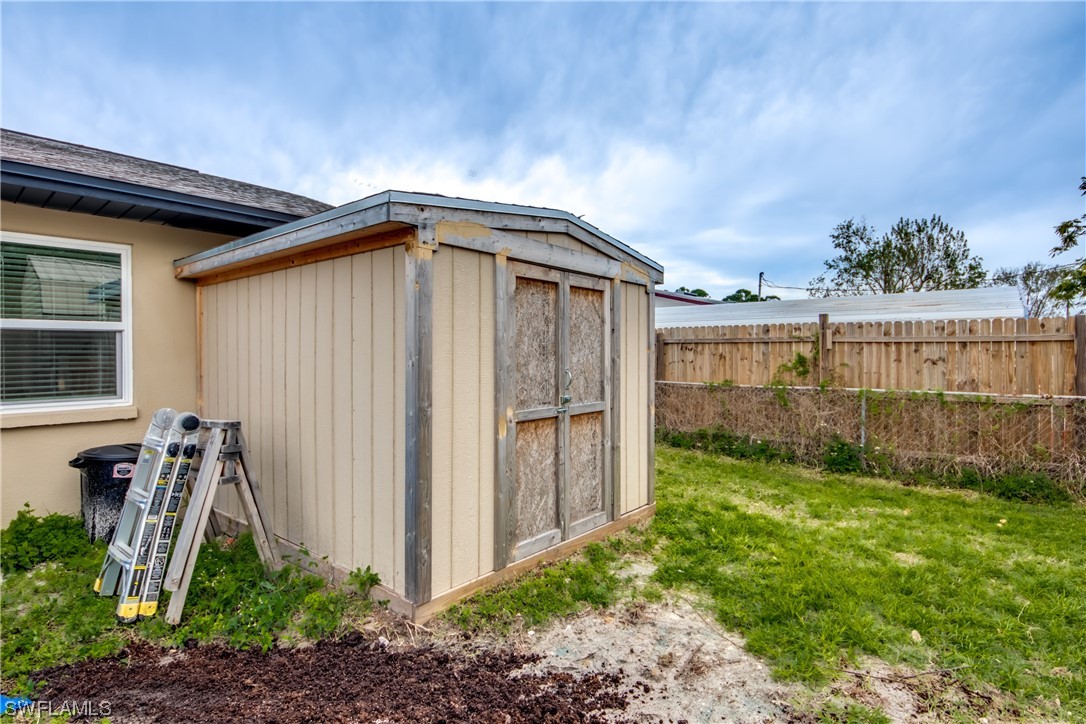 26508 Eager Road Punta Gorda, FL 33955 - Photo 41 of 41 a view of a backyard with potted plants and floor to ceiling window