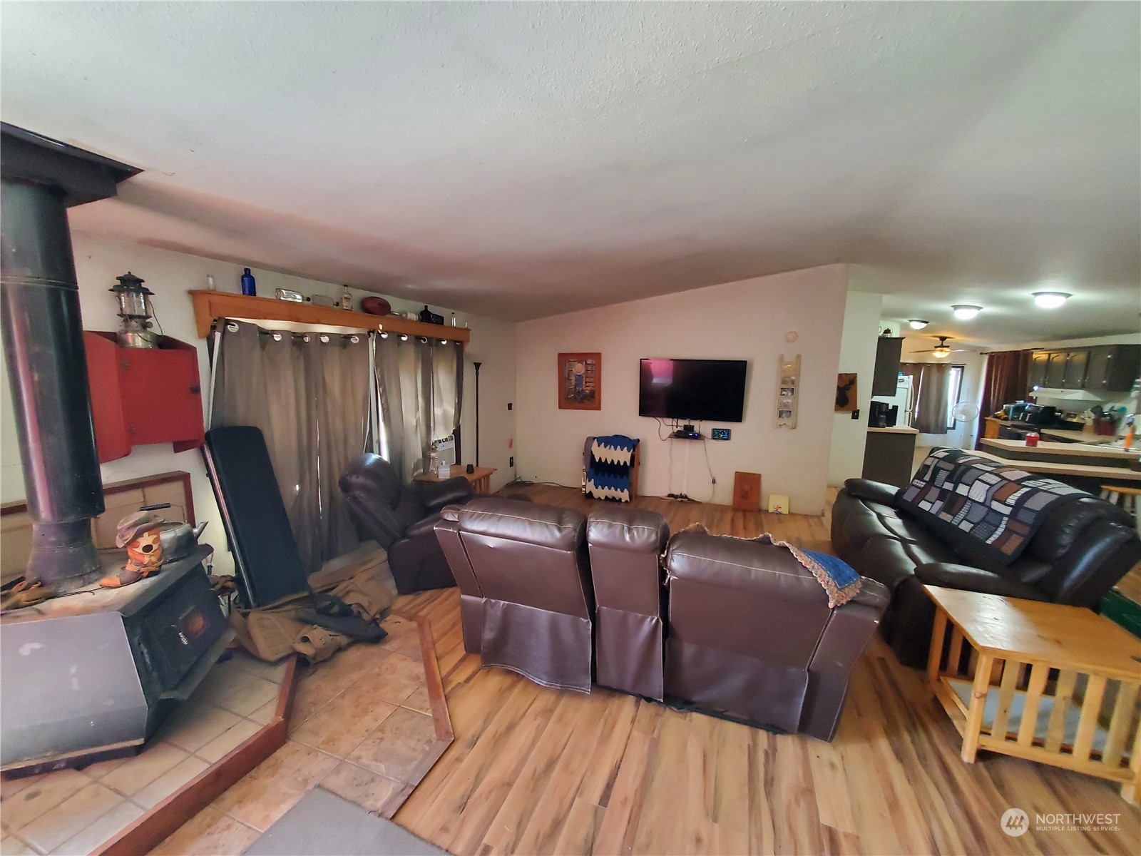507 Mt Olive Road Riverside, WA 98849 - Photo 13 of 23 a living room with furniture a flat screen tv and a fireplace