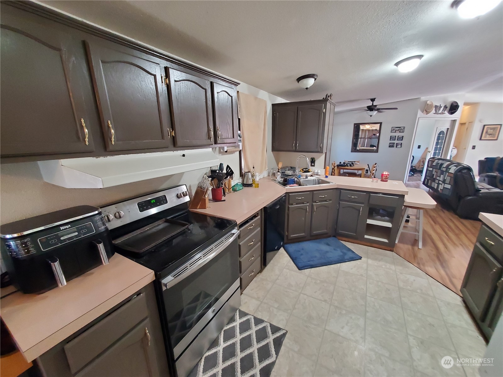 507 Mt Olive Road Riverside, WA 98849 - Photo 9 of 23 a kitchen with a stove a sink and a microwave