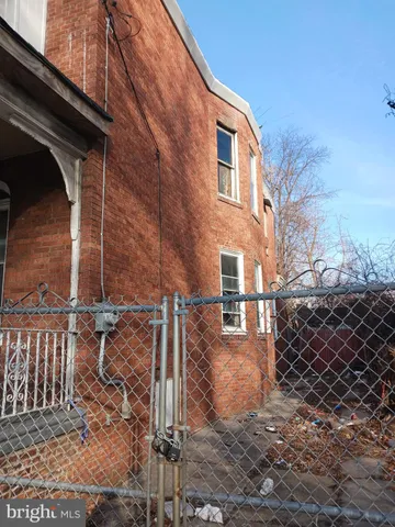 a view of a house with a wooden fence