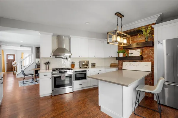 a kitchen with a stove a sink and a refrigerator