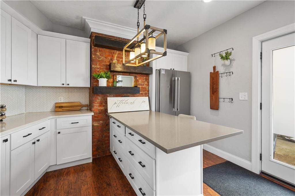 5101 Carnegie Street Pittsburgh, PA 15201 - Photo 13 of 34 a kitchen with stainless steel appliances a stove cabinets and wooden floor
