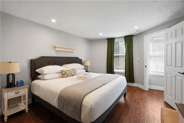 a bedroom with a bed and a night stand