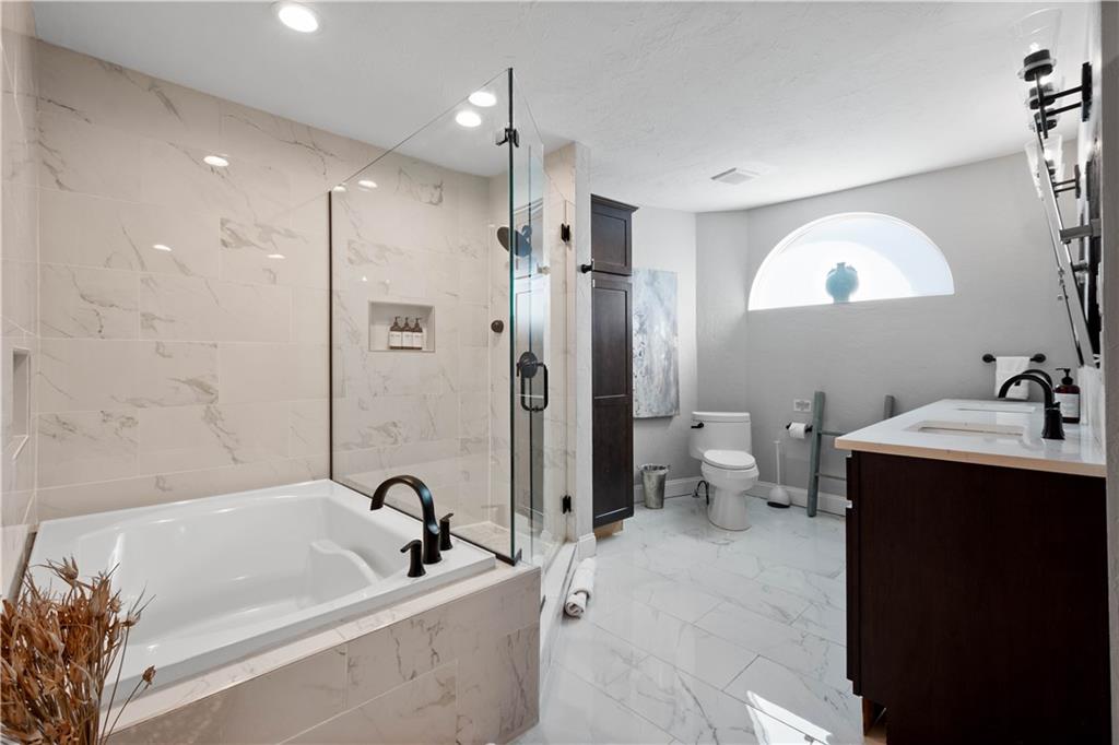 5101 Carnegie Street Pittsburgh, PA 15201 - Photo 17 of 34 a bathroom with a tub sink toilet and a mirror