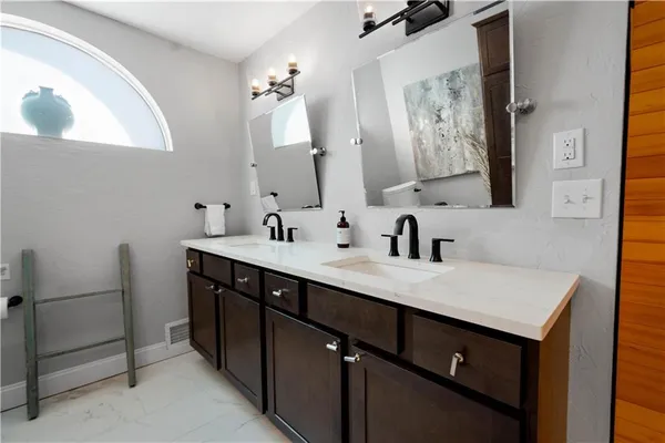 a bathroom with a double vanity sink mirror and