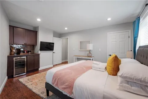 a bedroom with a bed and a television