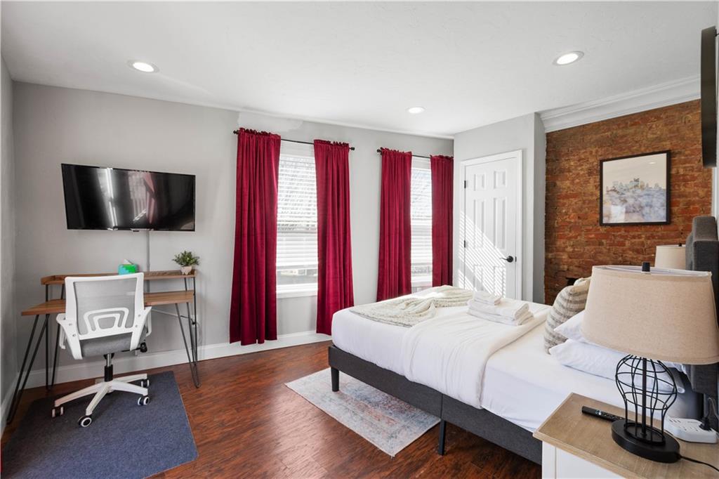 5101 Carnegie Street Pittsburgh, PA 15201 - Photo 25 of 34 a bedroom with a bed and a flat screen tv