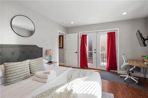 a bedroom with a bed and a chair