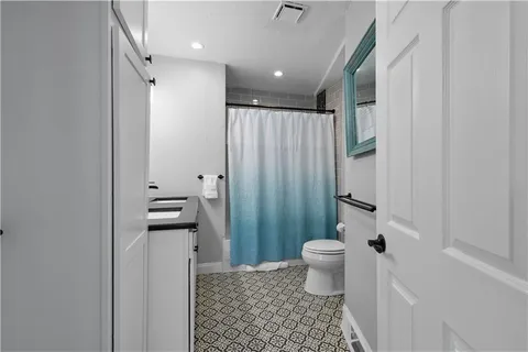 a bathroom with a toilet and a shower