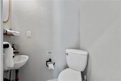 a white toilet sitting next to a bathroom sink
