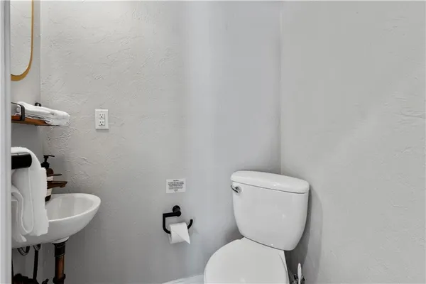 a white toilet sitting next to a bathroom sink